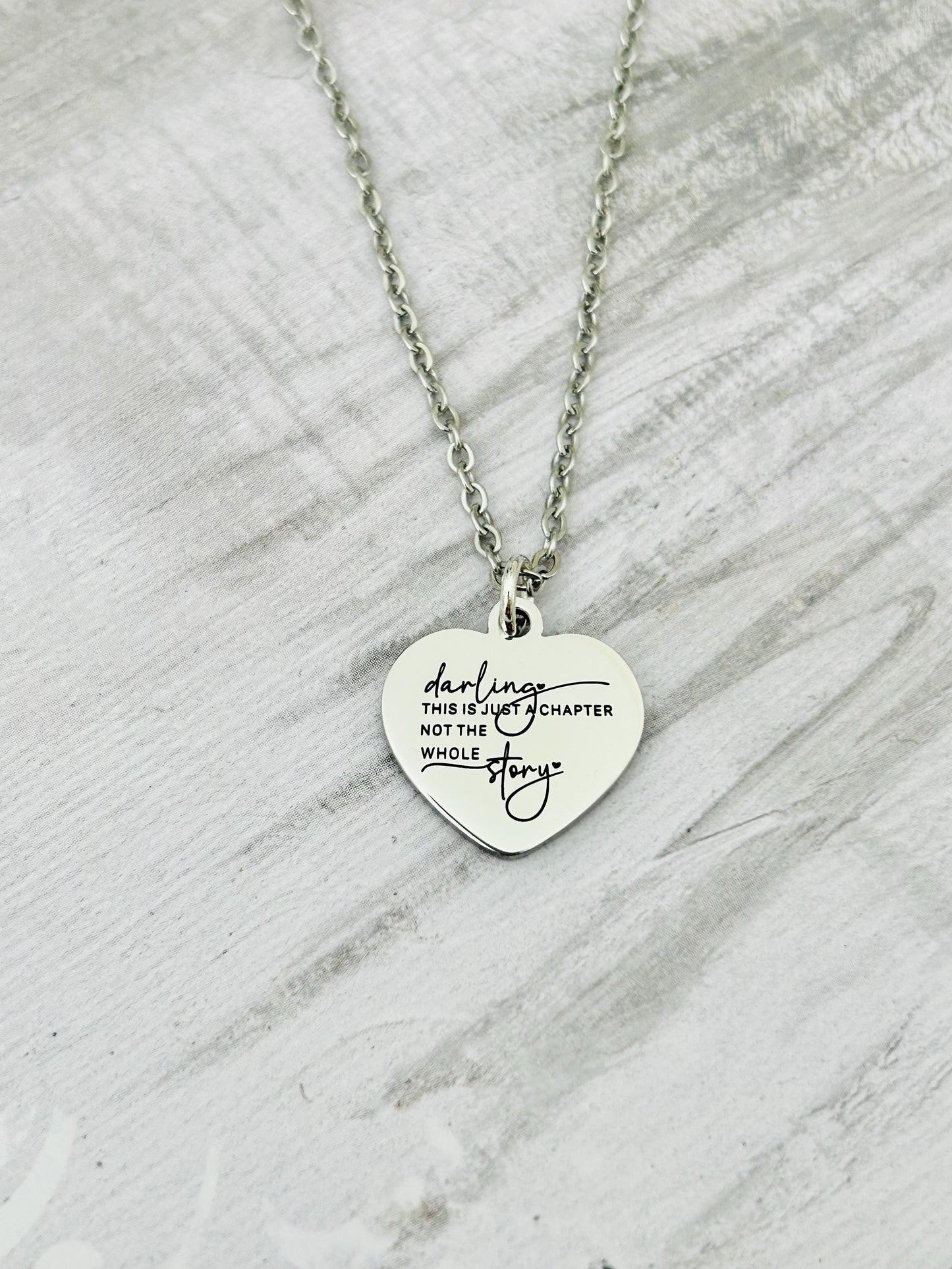 Motivational Stainless Steel Heart Necklace: 'Just A Chapter' Engraved Pendant